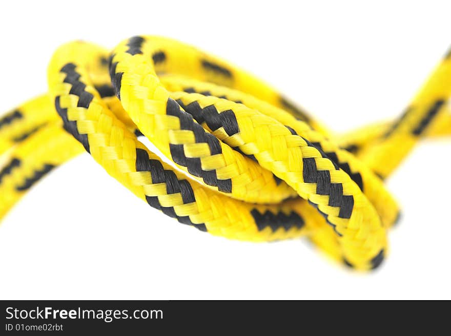 Knot of two yellow and black cords. Knot of two yellow and black cords