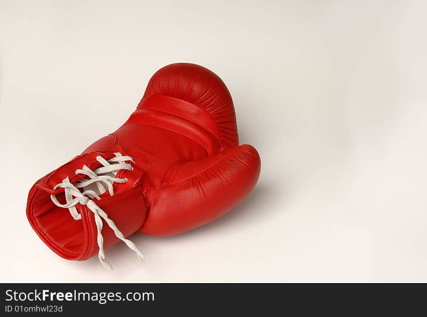 Red boxing glove with white lacing