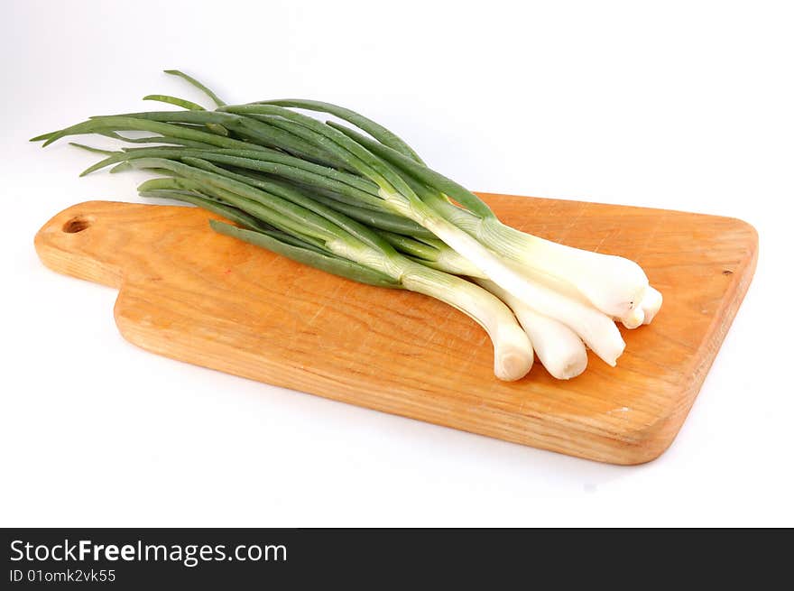 Spring onions on the threaded board