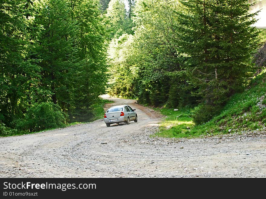 A crazy driver who drives with a very high speed on a forest road in the Bucegi mountains, Romania. A crazy driver who drives with a very high speed on a forest road in the Bucegi mountains, Romania.