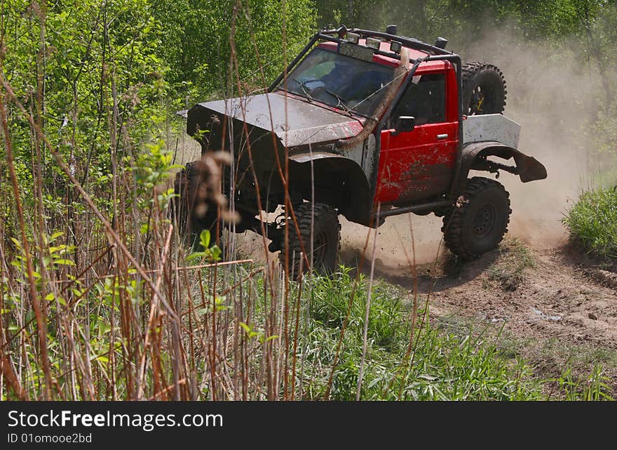 Off-road car stiring up the dust