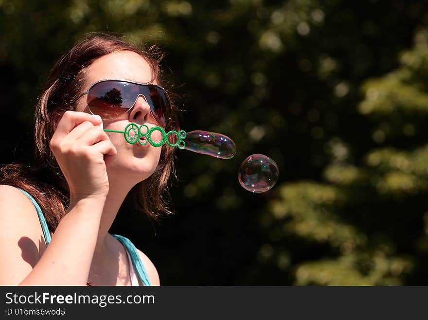 Girl blows in free bubbles. Girl blows in free bubbles