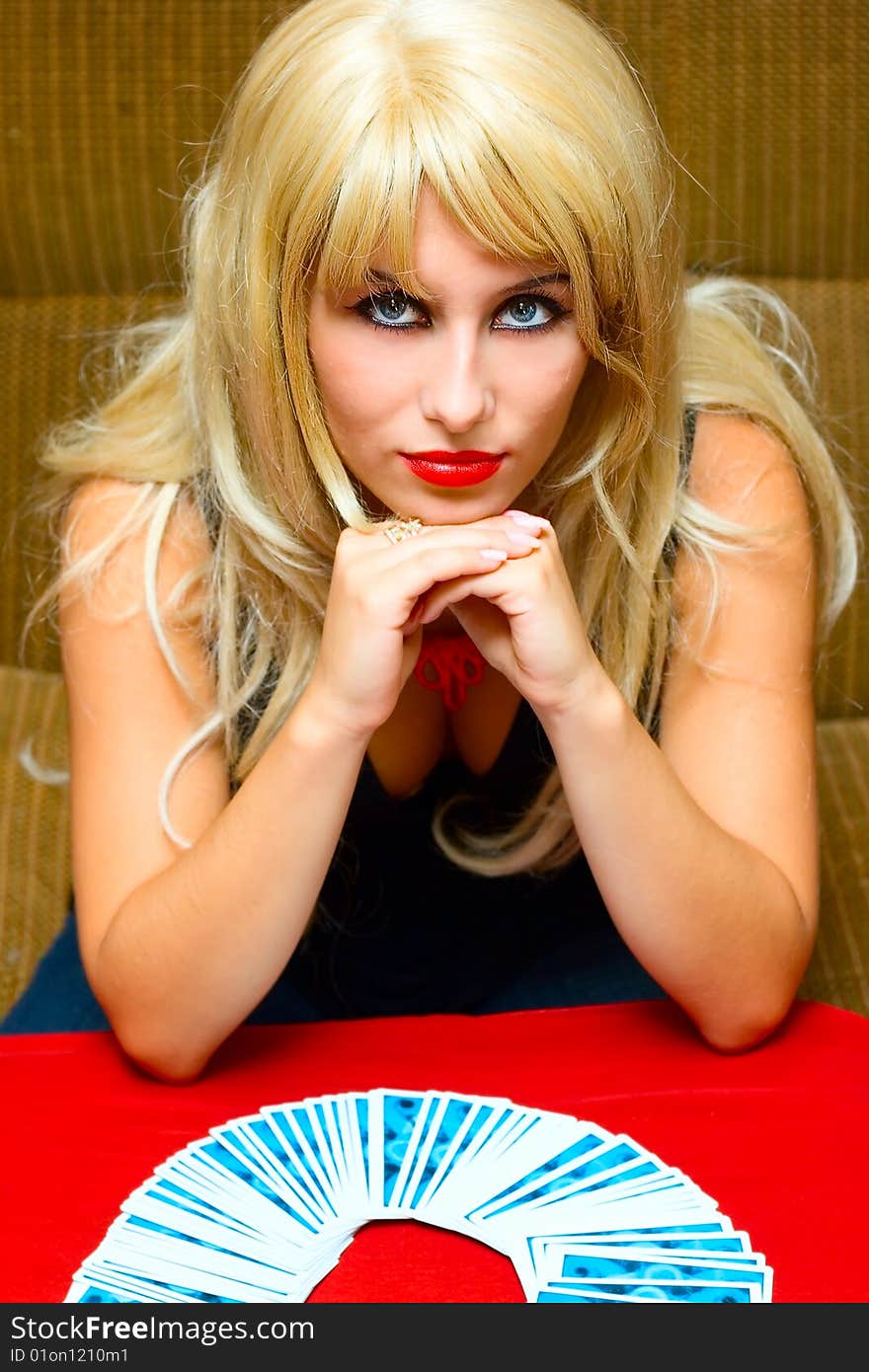 Portrait mistic blonde girl with cards