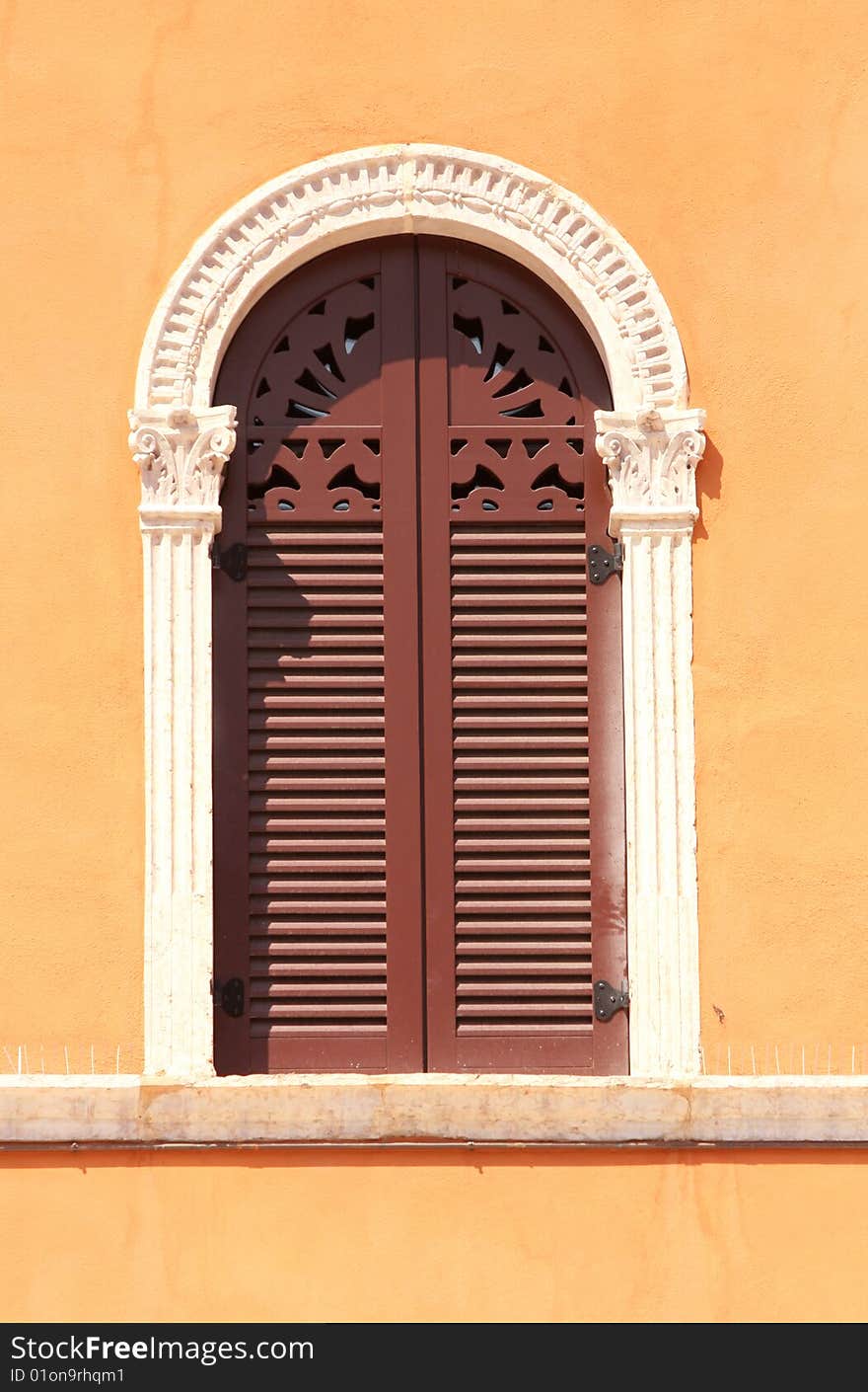 Beautiful windows and a orange wall in piazza Signoria, Verona, Italy. Beautiful windows and a orange wall in piazza Signoria, Verona, Italy