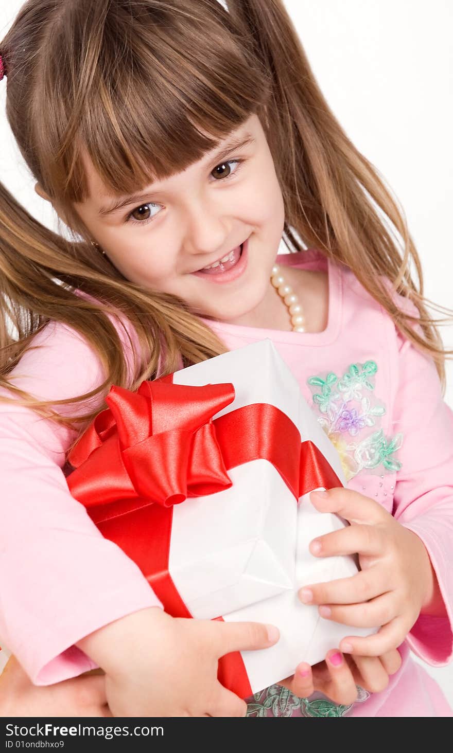 Adorable little girl with white gift box