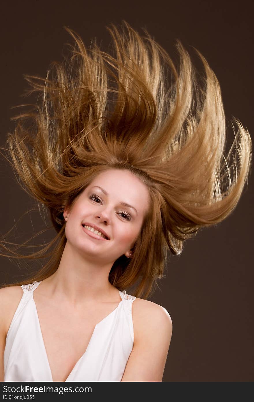 Happy young  girl with long flying hair