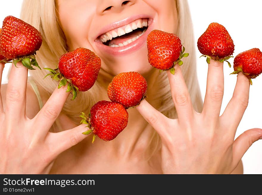 Sweet caucasian girl eating strawberries picked on fingertips