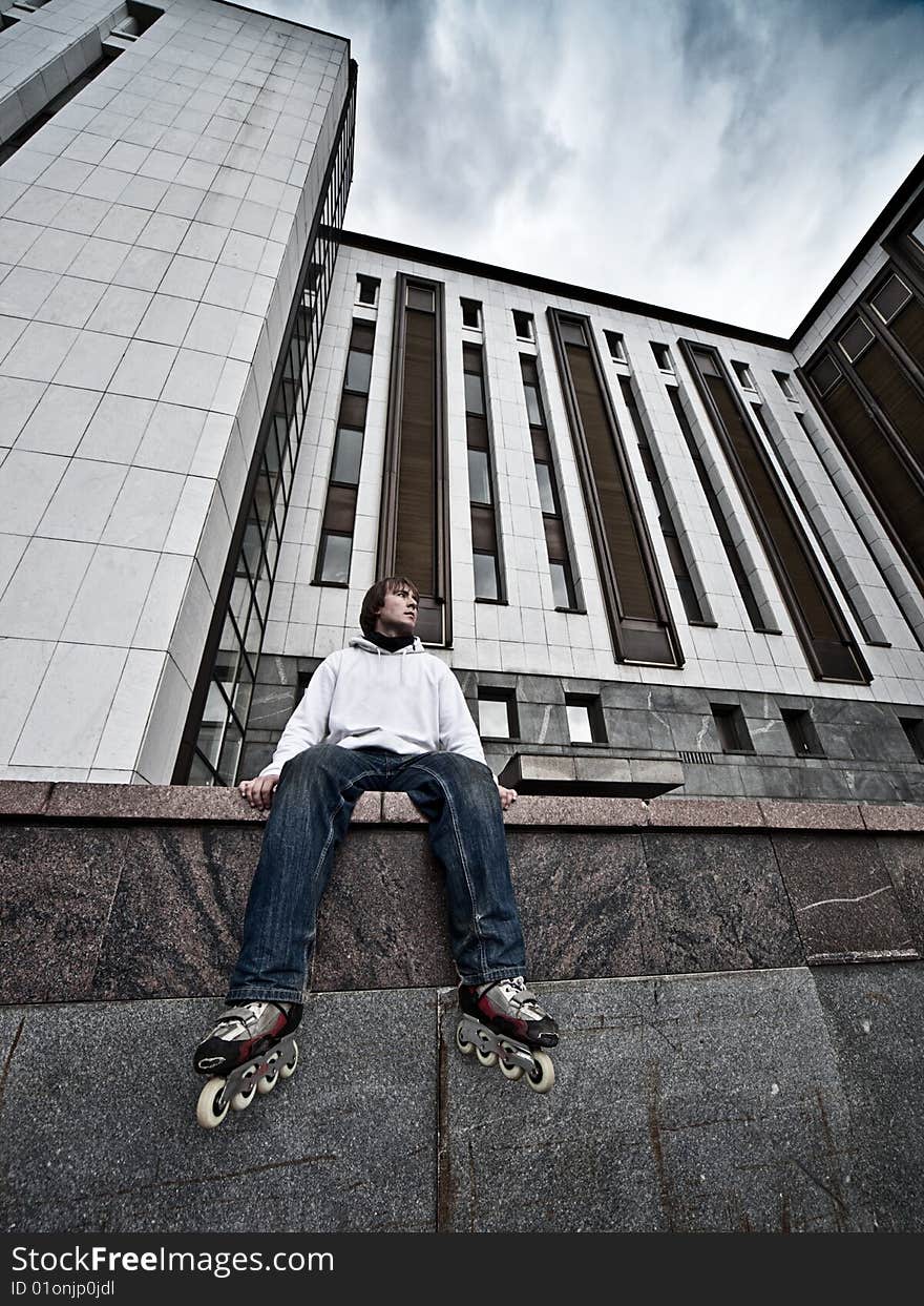 Wide angle portrait of a serious rollerskating man. Wide angle portrait of a serious rollerskating man