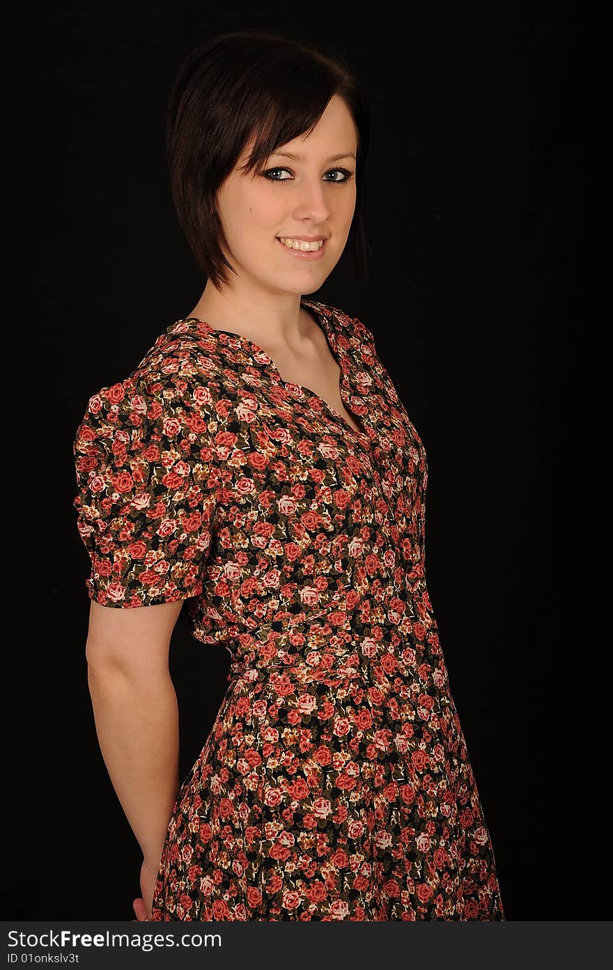 Horizontal closeup portrait of a smiling young woman, isolated against a black background. Horizontal closeup portrait of a smiling young woman, isolated against a black background.