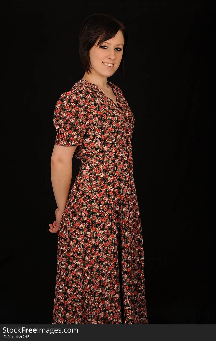 A formal portrait of a dark haired teenage girl.  Black background. A formal portrait of a dark haired teenage girl.  Black background