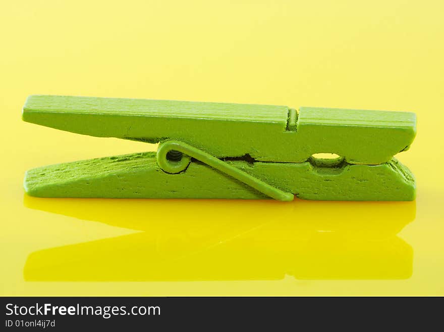 Stiled clothespin on yellow glass