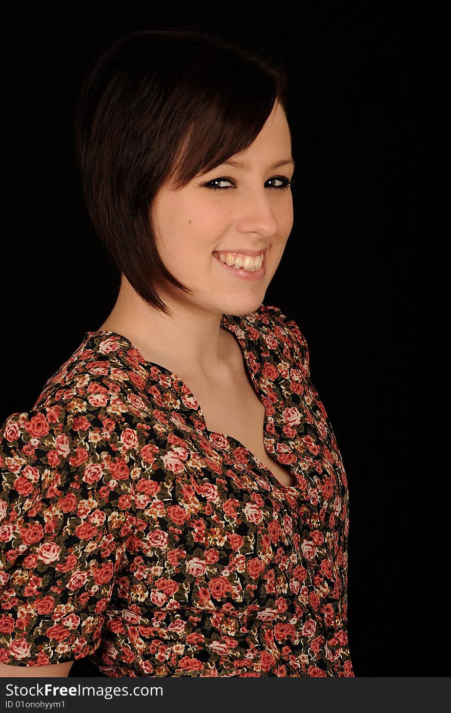 Horizontal closeup portrait of a smiling young woman, isolated against a black background. Horizontal closeup portrait of a smiling young woman, isolated against a black background.