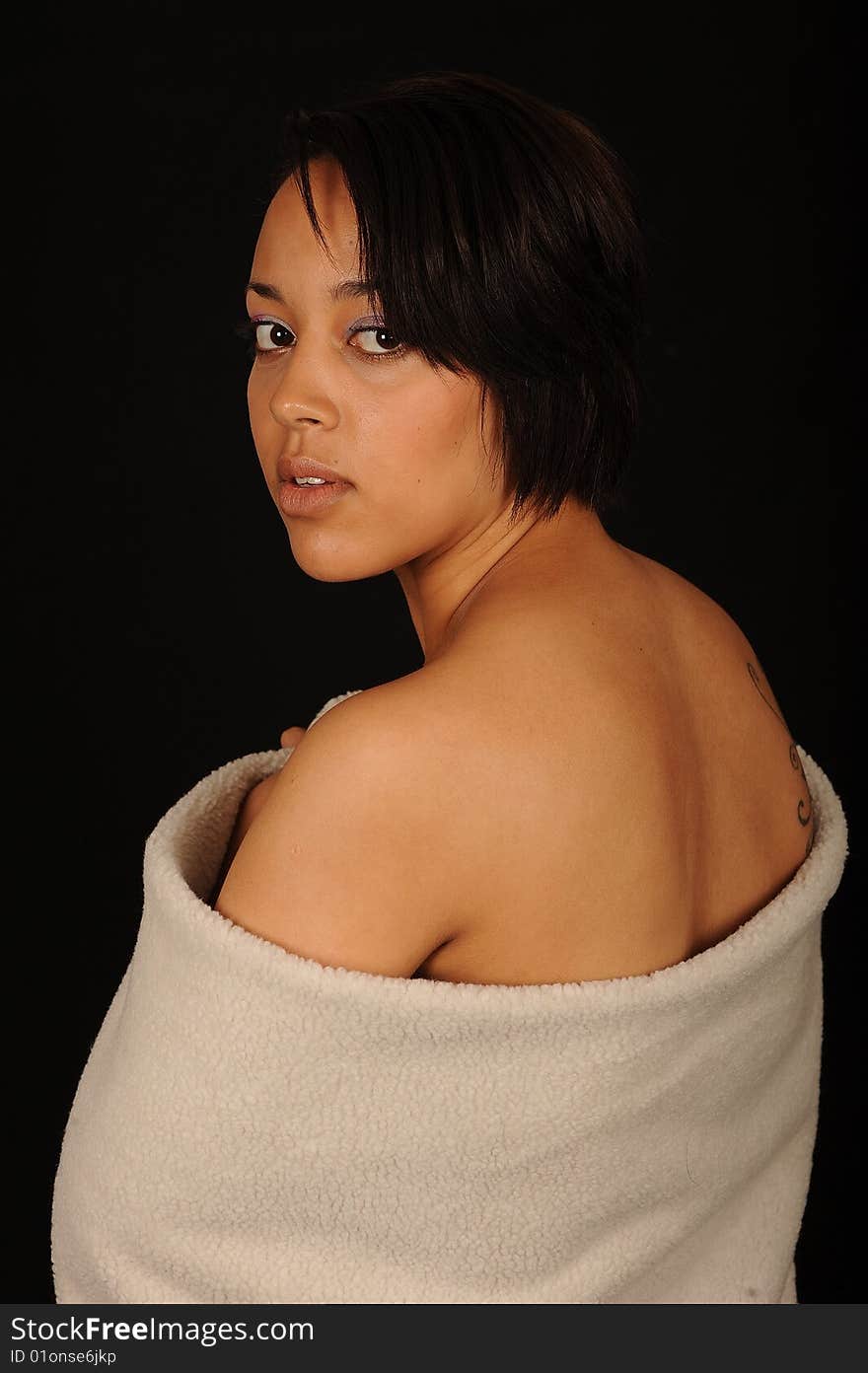 A closeup portrait of a pretty African American teenage woman. Black background. A closeup portrait of a pretty African American teenage woman. Black background