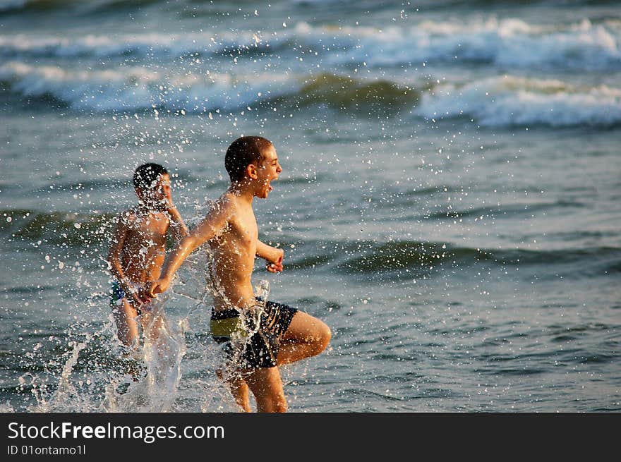 Happy boys who plunge into the sea. Happy boys who plunge into the sea