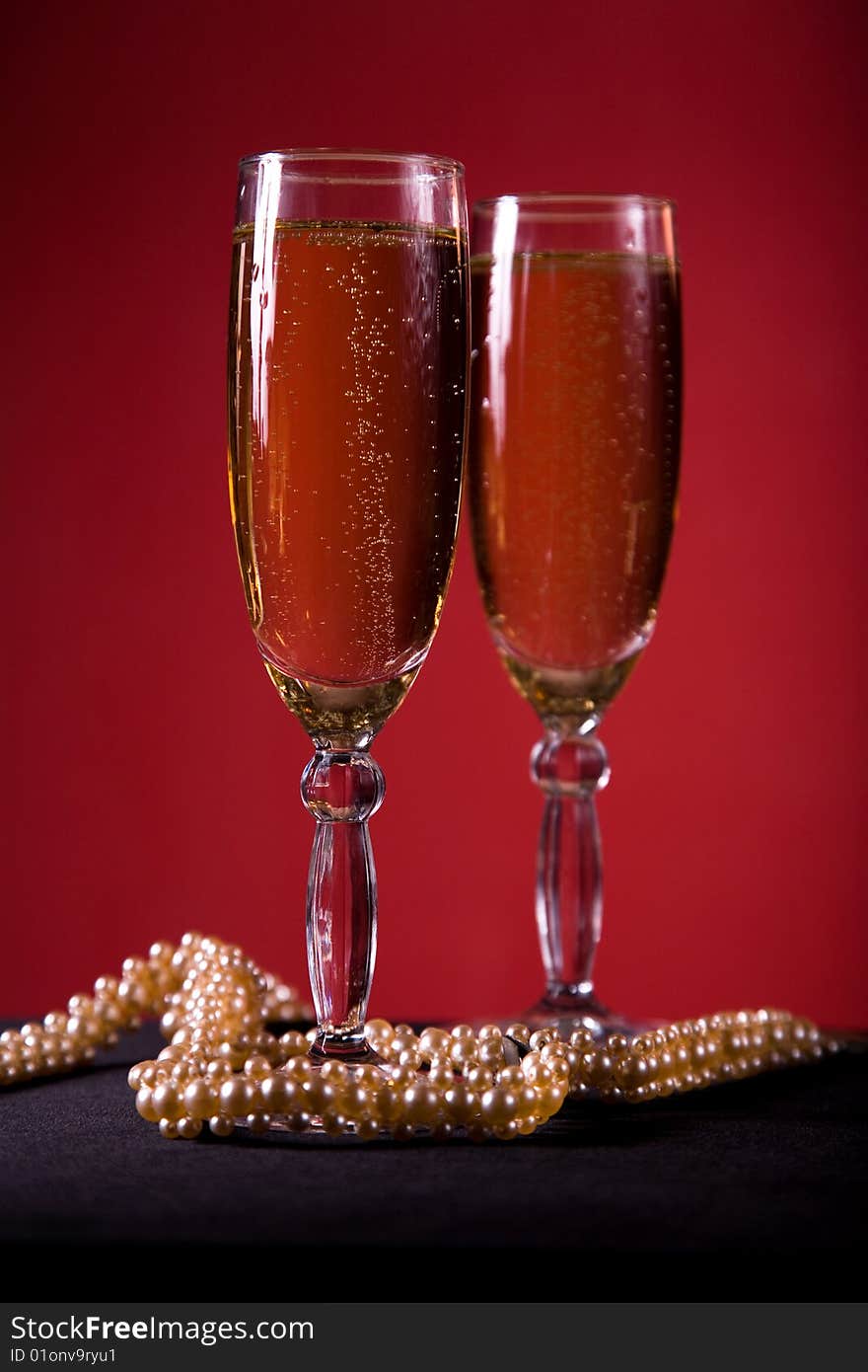 Champagne glasses with pearl necklace, selective focus