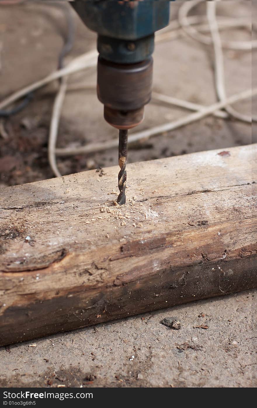 Drill drilling old wooden board