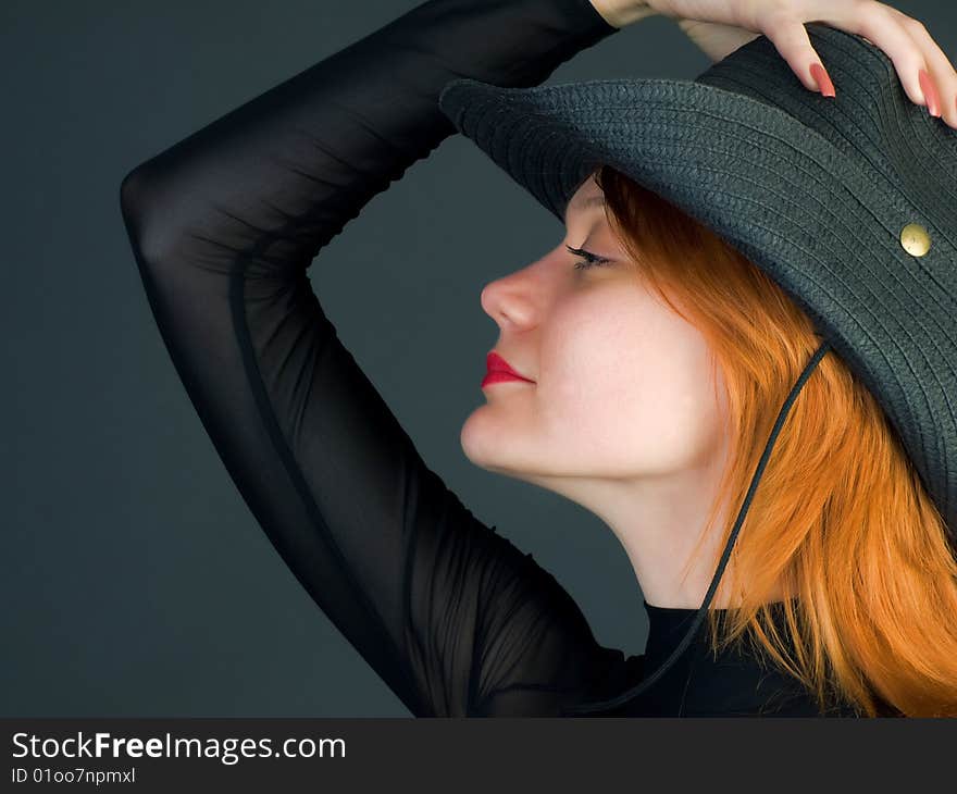 Sexy red young woman wearing a cowboy hat. Sexy red young woman wearing a cowboy hat