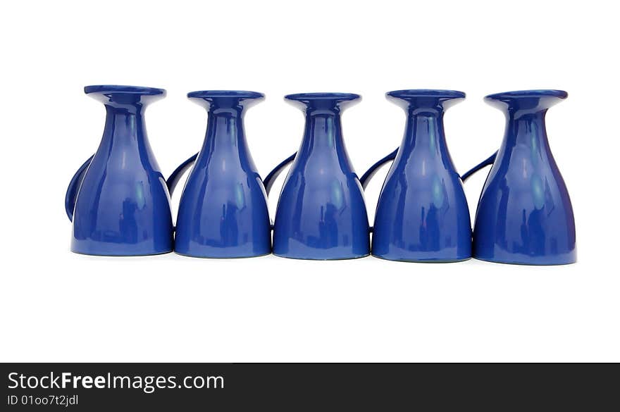 Row of five blue long-stemmed coffee cups upside down isolated. Row of five blue long-stemmed coffee cups upside down isolated