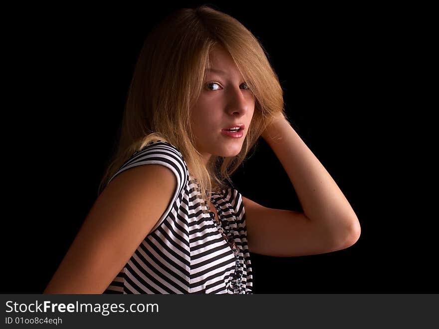 Beautiful portrait of a young girl with expressive eyes on the black background. Beautiful portrait of a young girl with expressive eyes on the black background