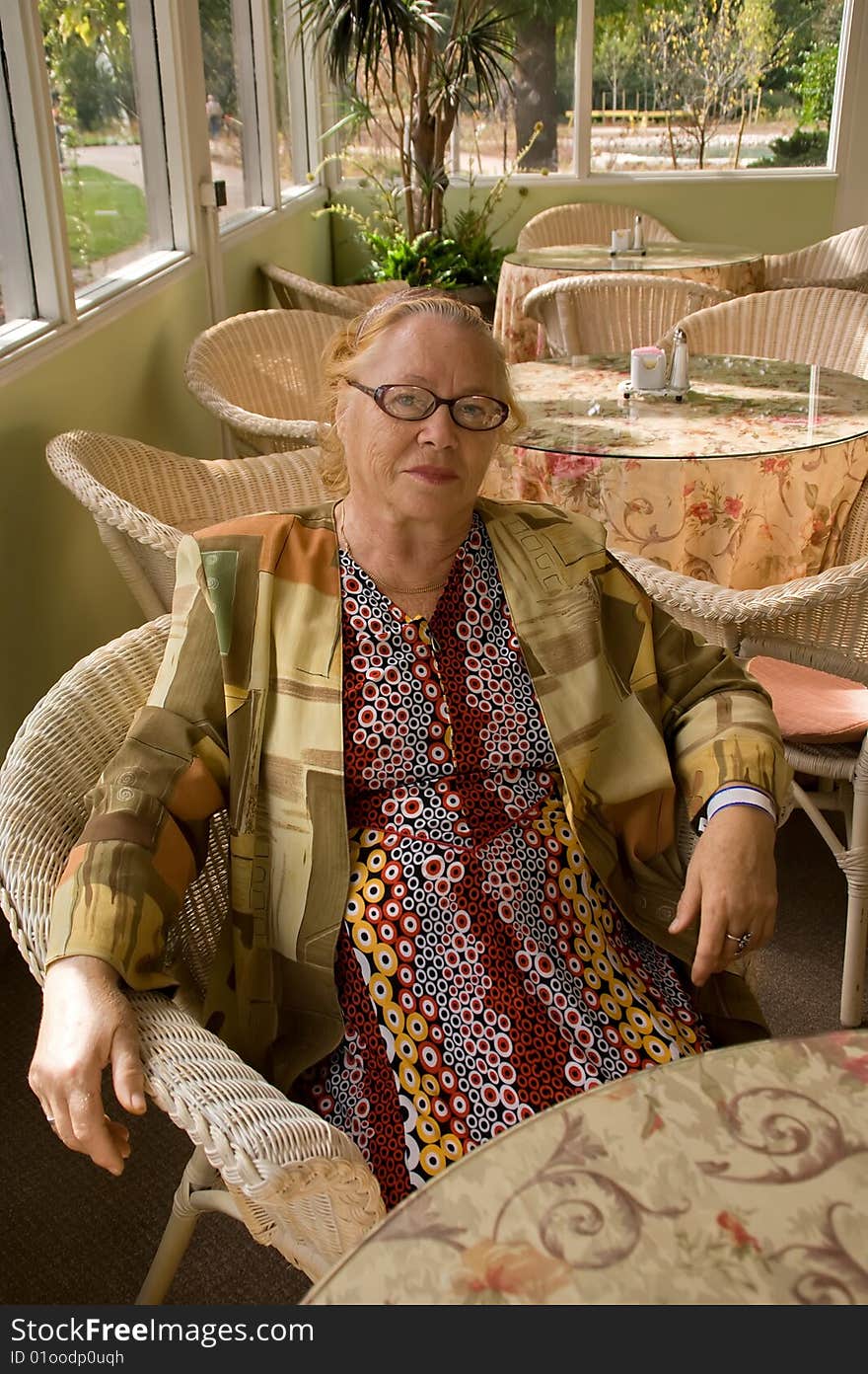 Smiling 60+ senior woman relaxing in cafe. Smiling 60+ senior woman relaxing in cafe