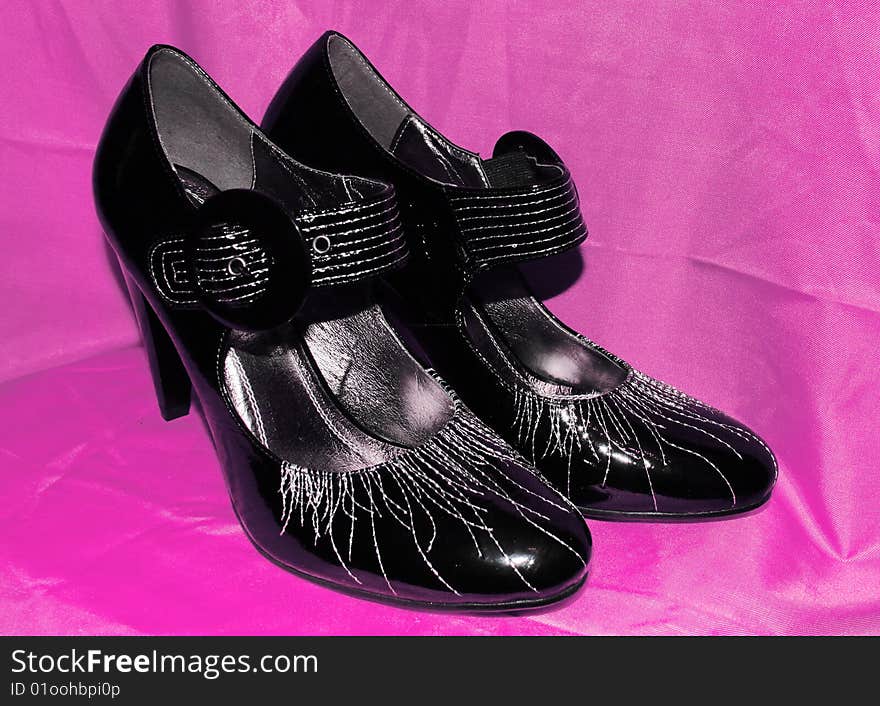 Black shoes with silvery decor.