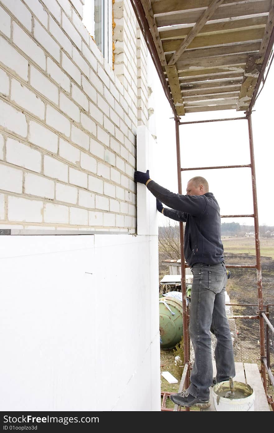 Master glue polystyrene the plate on wall of the building