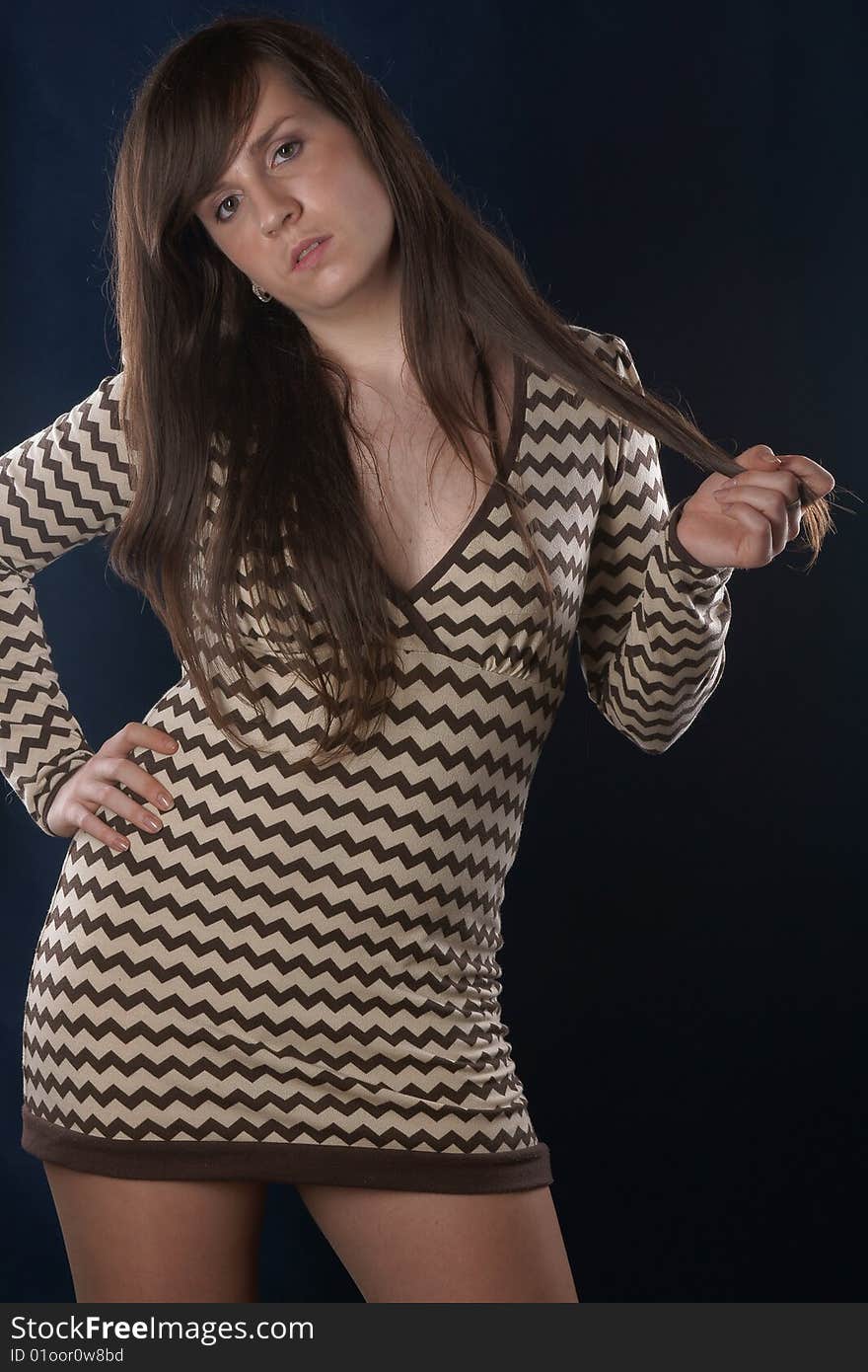 The portrait of the beautiful girl is photographed on a dark blue background