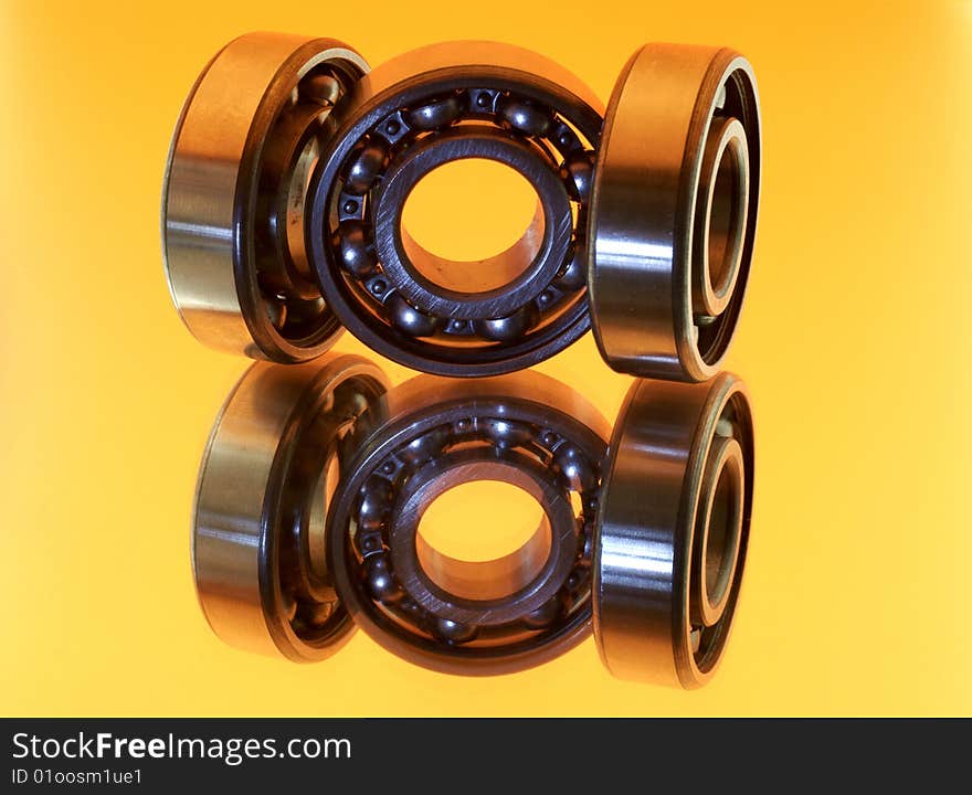 Bearings On Yellow Background - Reflection