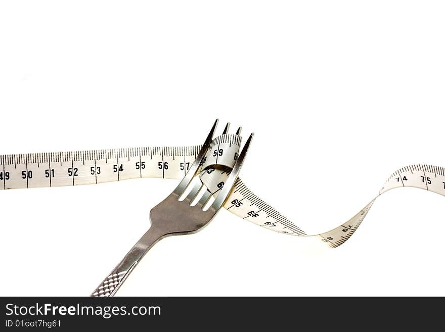 Conceptual image of a fork twirling a measuring tape off of a plate. Conceptual image of a fork twirling a measuring tape off of a plate