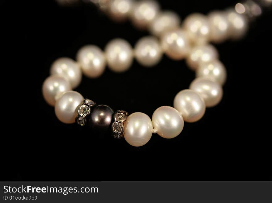 Pearl beads on the black background