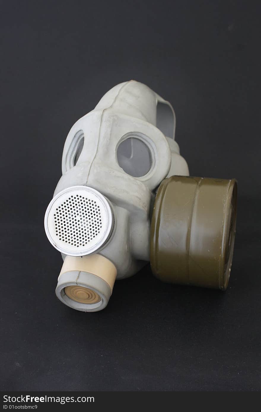 Gas mask over black background