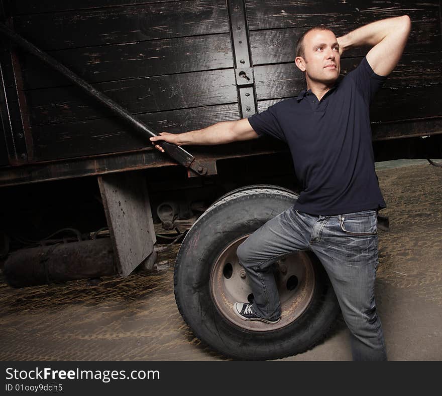 Handsome young man posing by a truck