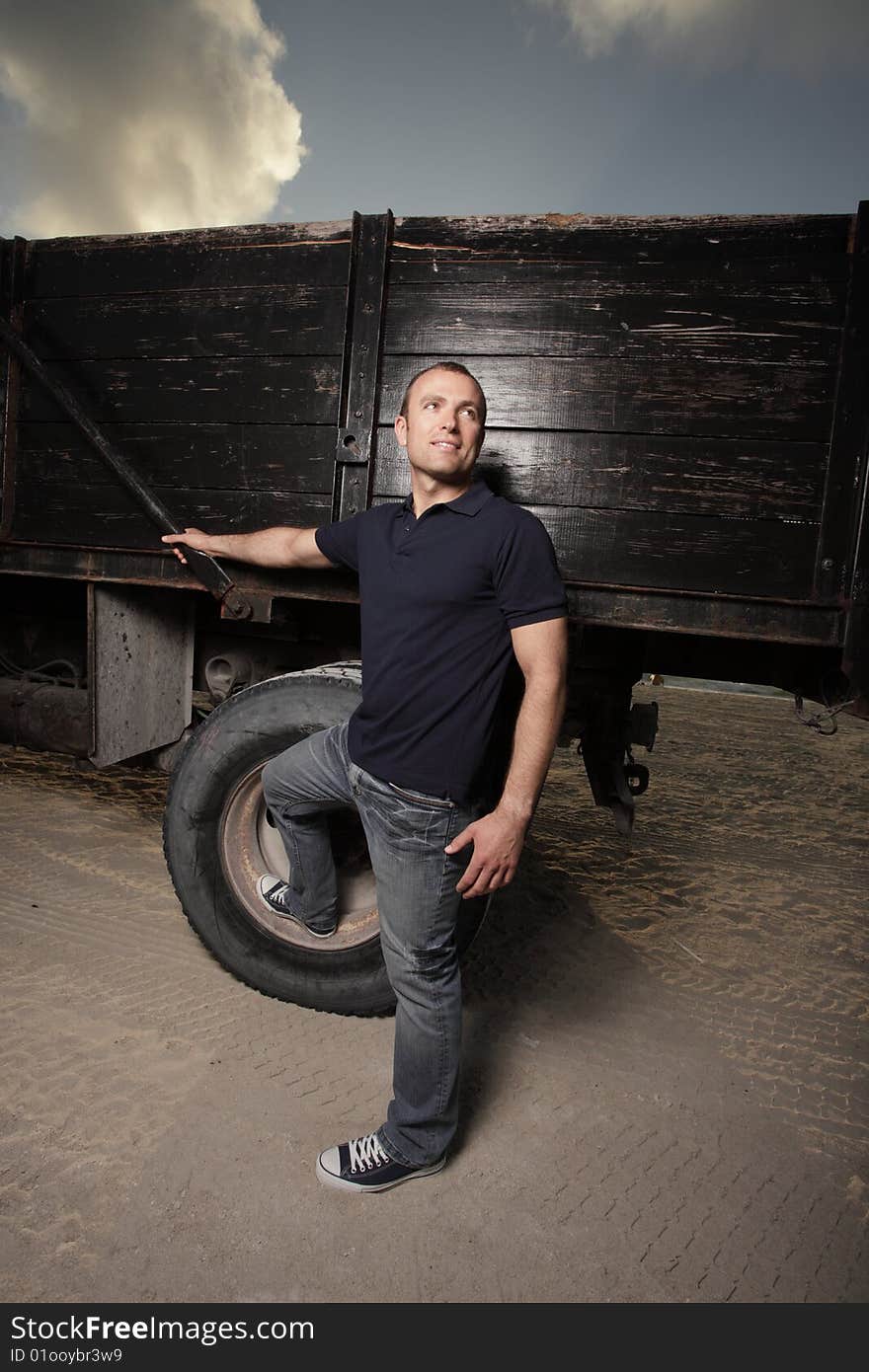 Handsome young man posing by a truck