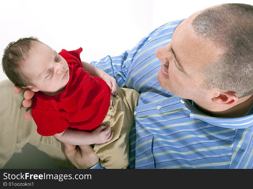 Father holding newborn baby boy in his hands. Father holding newborn baby boy in his hands