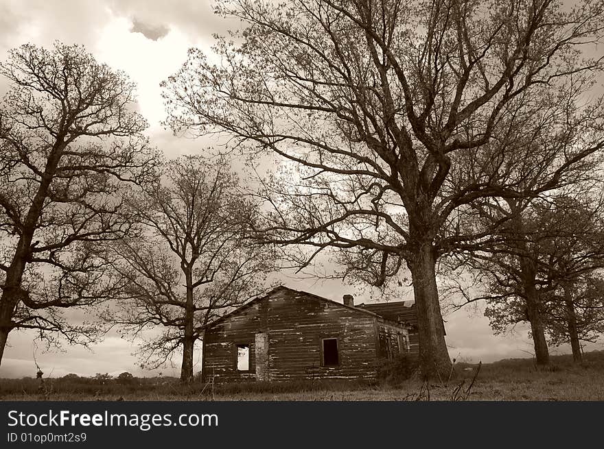 An abandoned farm house spotlighted by the sun. An abandoned farm house spotlighted by the sun.