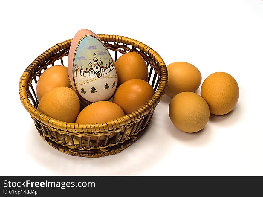 Easter egg in basket on a white