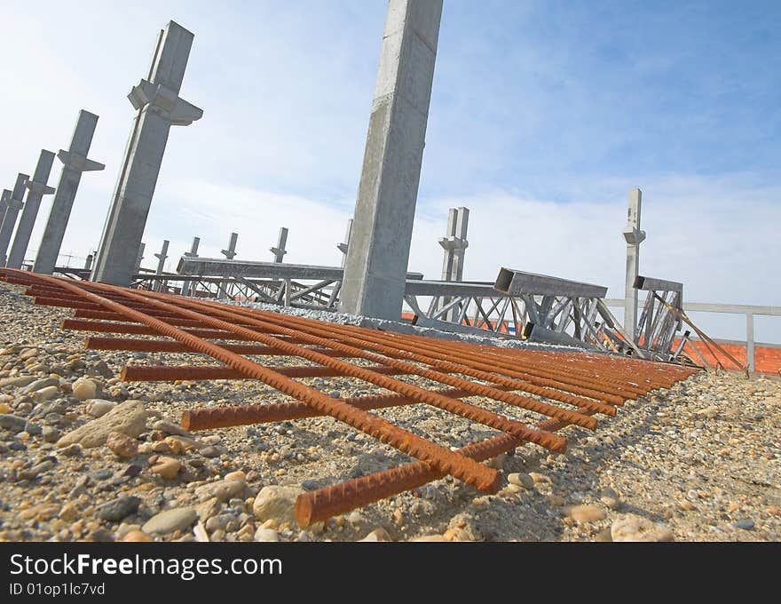 Construction site with enforced steel concrete pillions rising up