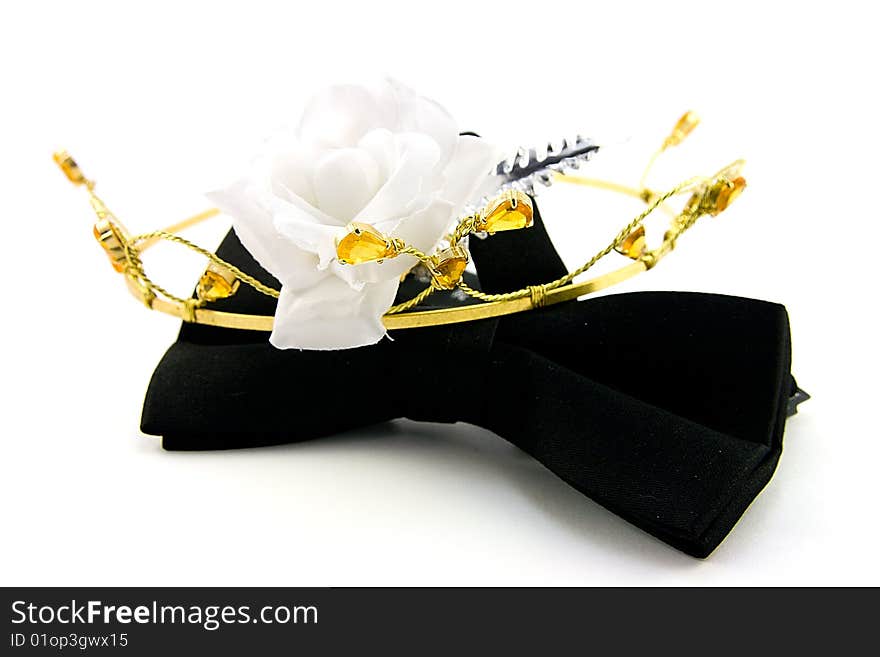 Single Black Bow Tie with Tiara and single white rose on a white Background. Single Black Bow Tie with Tiara and single white rose on a white Background
