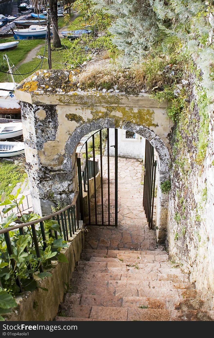 Entrance in old port, arch and gate with lichen and moss, Corfu, Greece