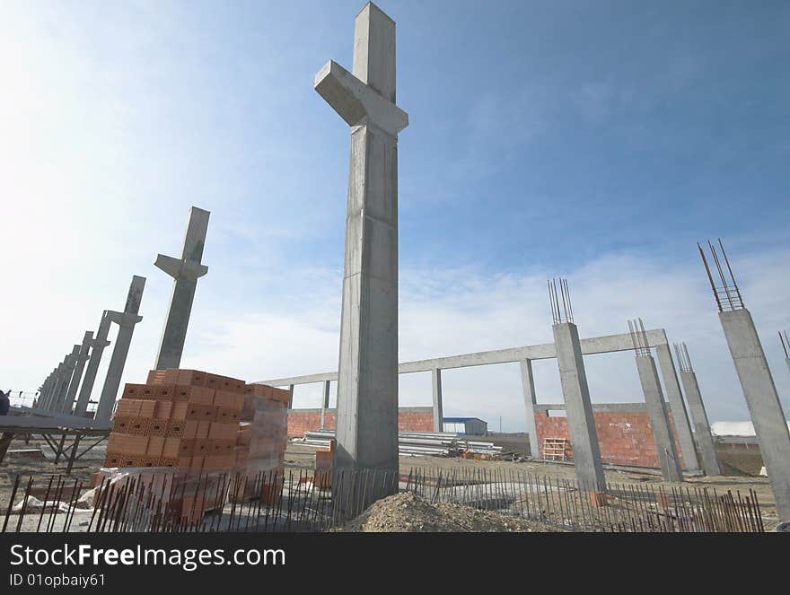 Construction site with enforced steel concrete pillions rising up