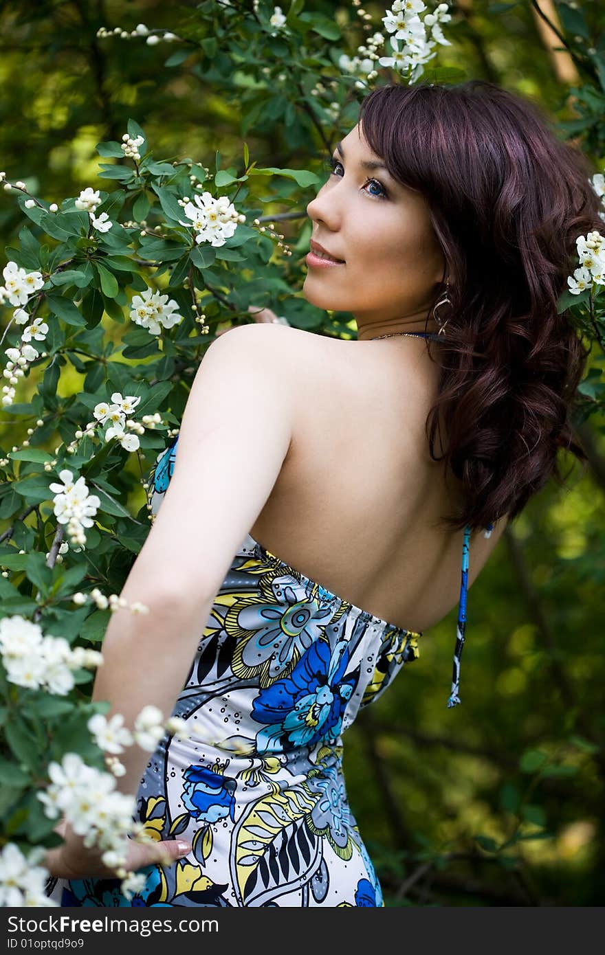 Tender girl in the garden with flowerings trees