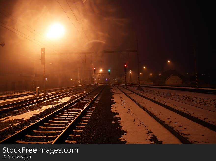 Railway in winter, haze and dark