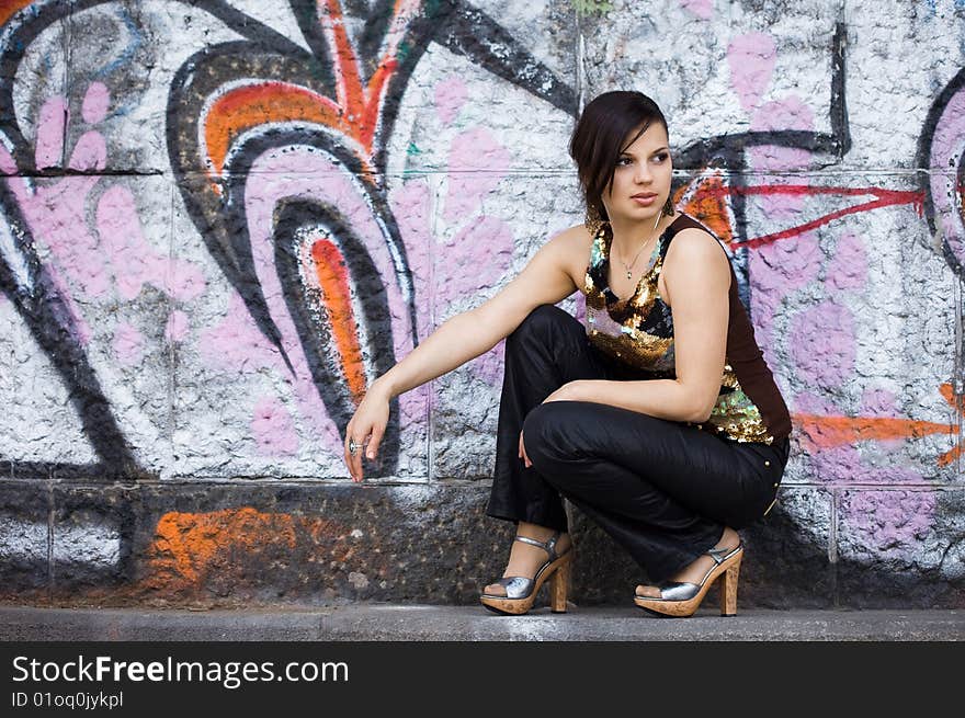 Girl near the wall with graffiti