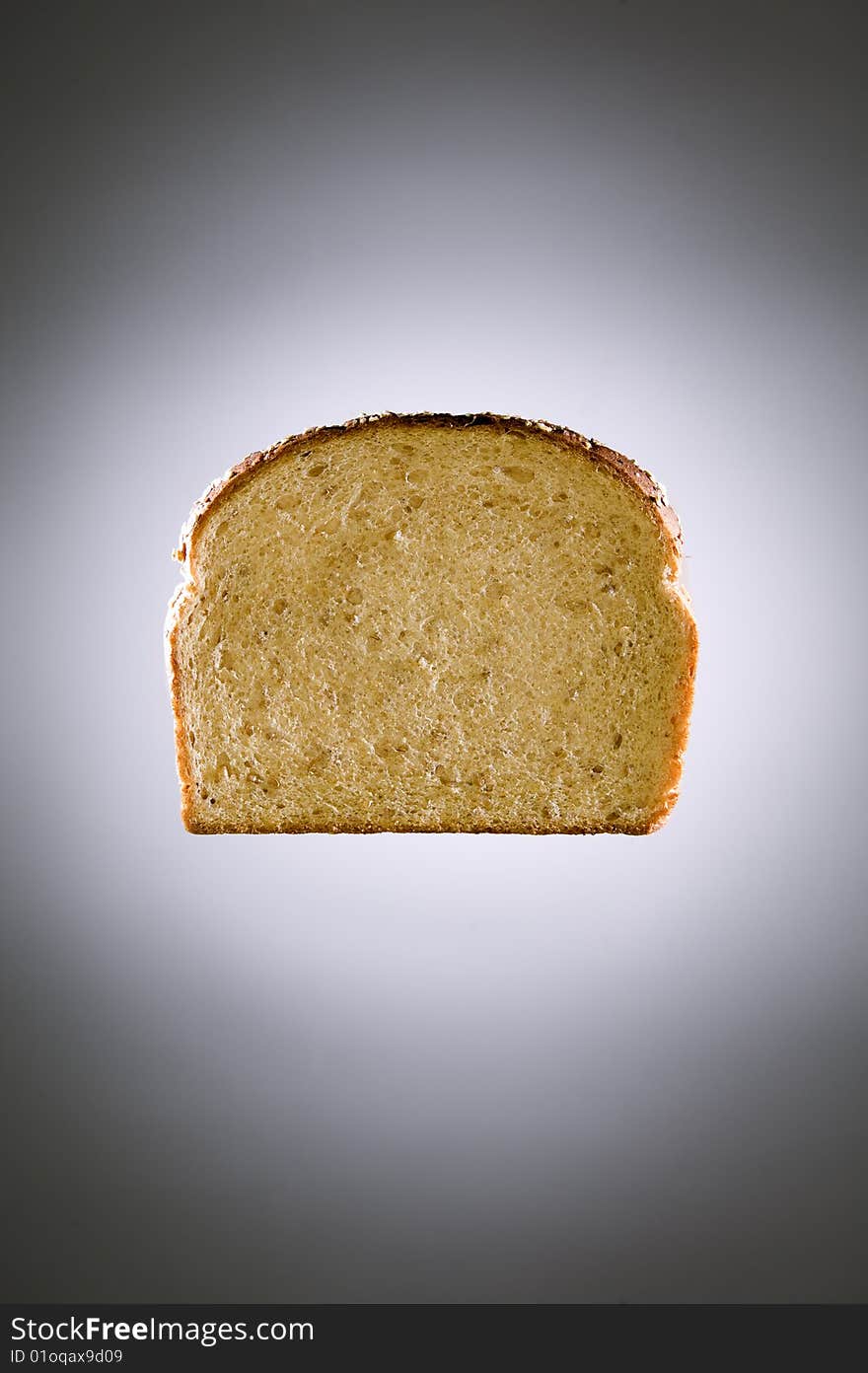 Multigrain bread floating in front of a gray backdrop. Multigrain bread floating in front of a gray backdrop.