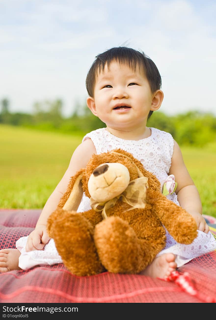 Portrait of an asian infant girl taken outdoors in an open park. Portrait of an asian infant girl taken outdoors in an open park