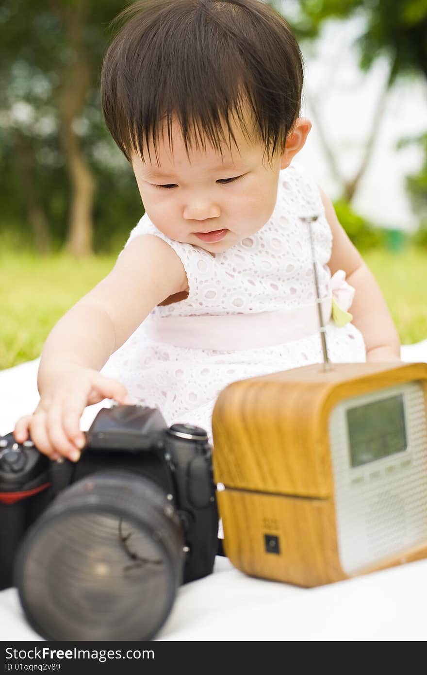 Portrait of an asian infant girl taken outdoors in an open park. Portrait of an asian infant girl taken outdoors in an open park