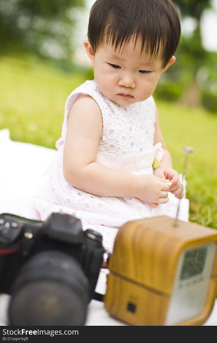 Portrait of an asian infant girl taken outdoors in an open park. Portrait of an asian infant girl taken outdoors in an open park