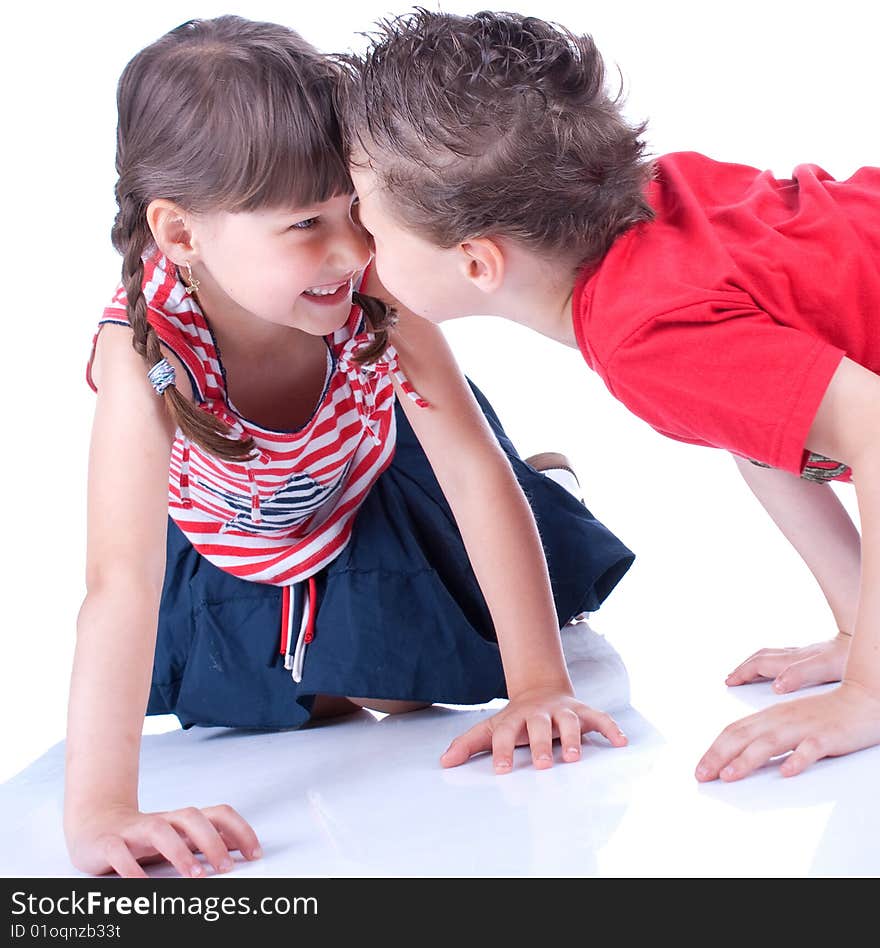 Cute blue-eyed boy and girl are playing , stidio shot