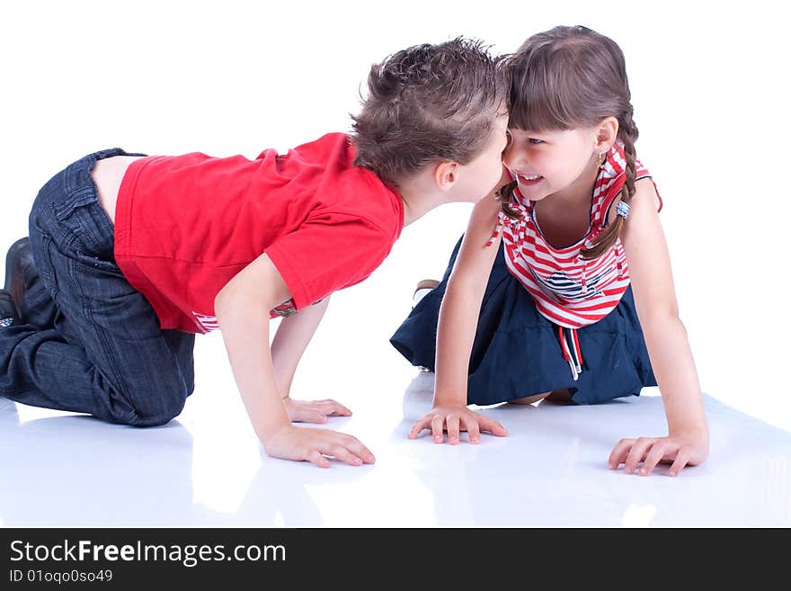 Brother and sister are playing on the floor