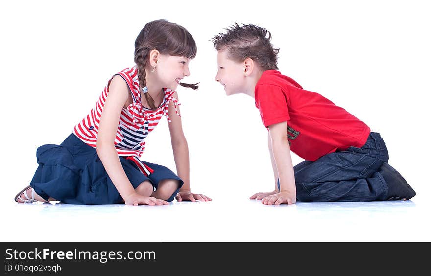 Cute blue-eyed boy and girl are playing , stidio shot